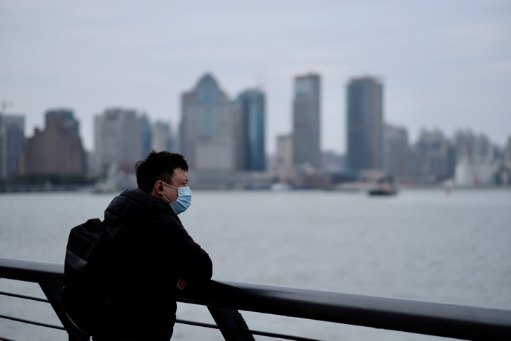 One Man Wearing Surgical Mask Leaning On Balustrade At The Bund In China