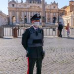 An Italian Policeman With Medical Mask Controls Access To The Square Of St. Peter's Basilica