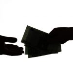 Silhouette Of Business Man Hands Giving Bribe Isolated On White Background. Dark Economy, Corruption Concept