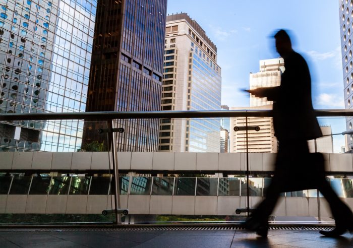 Blurred Motion Silhouette Of Businessman Walking In Hong Kong’s Central District Elevated Walkway